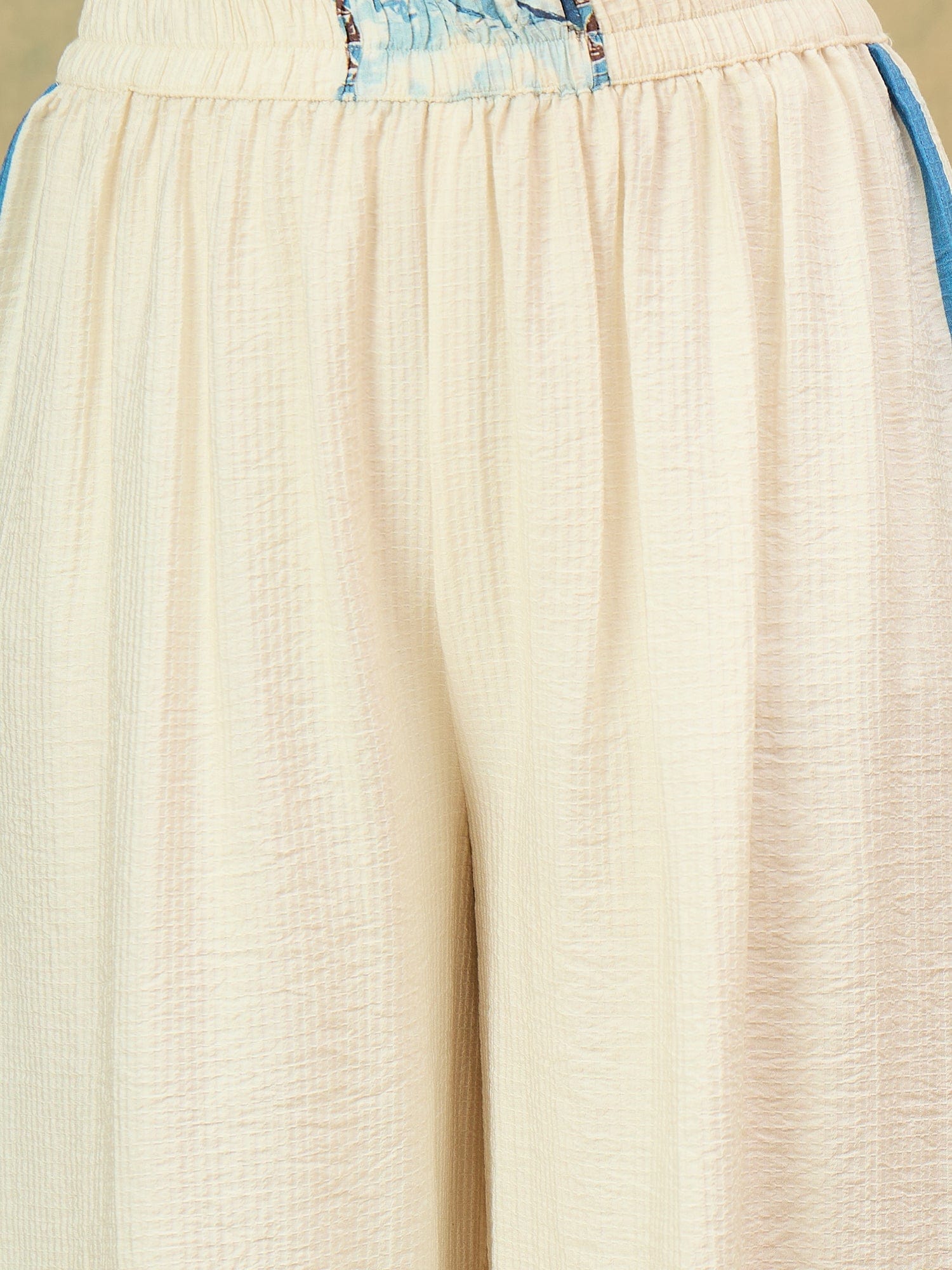 Off-white printed co-ord set featuring a sleeveless V-neck top and relaxed palazzo trousers for a chic, casual look