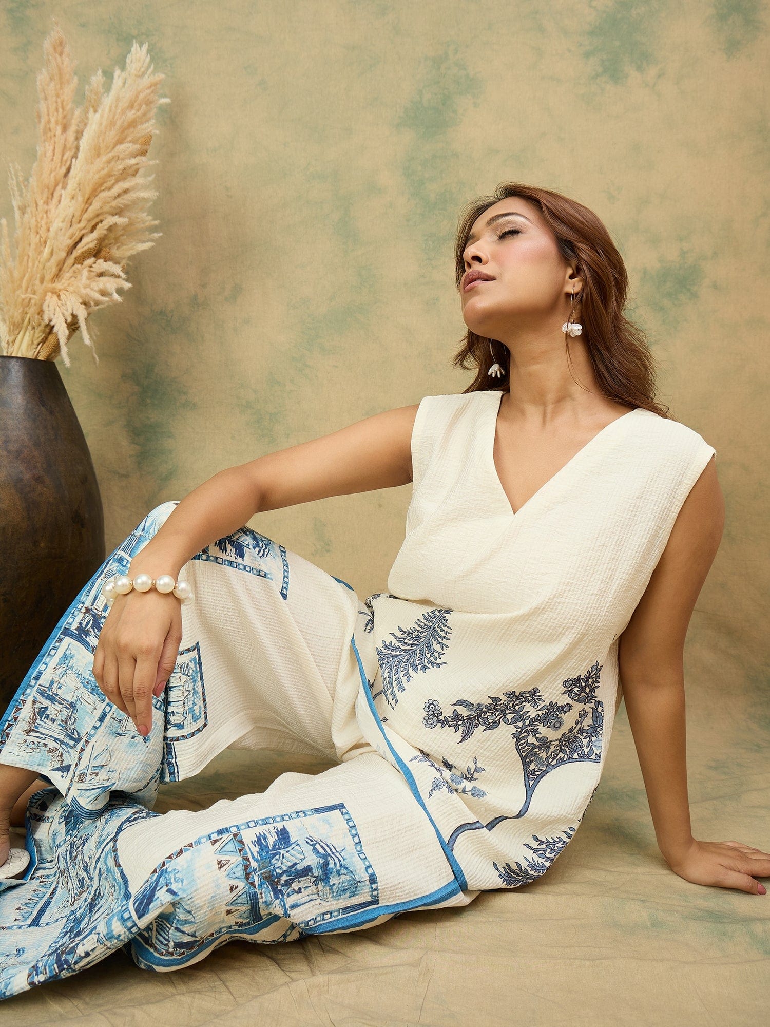 Off-white printed co-ord set featuring a sleeveless V-neck top and relaxed palazzo trousers for a chic, casual look