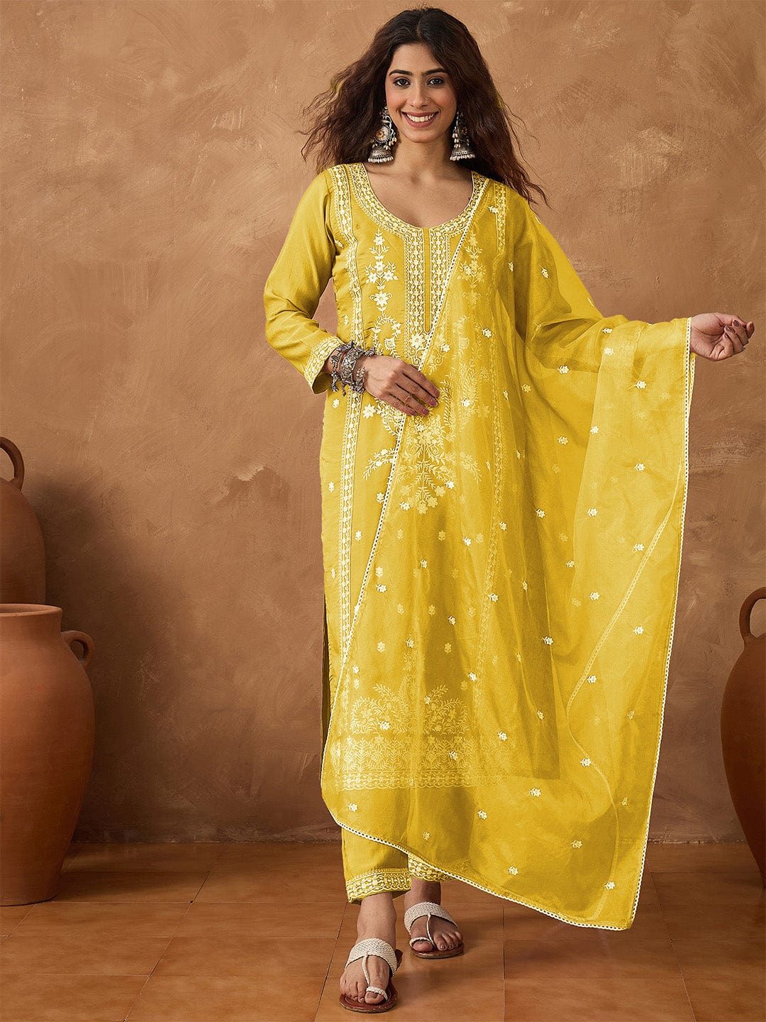 Kurta with thread embroidery paired with trousers with embroidered hem and booti embroidered dupatta