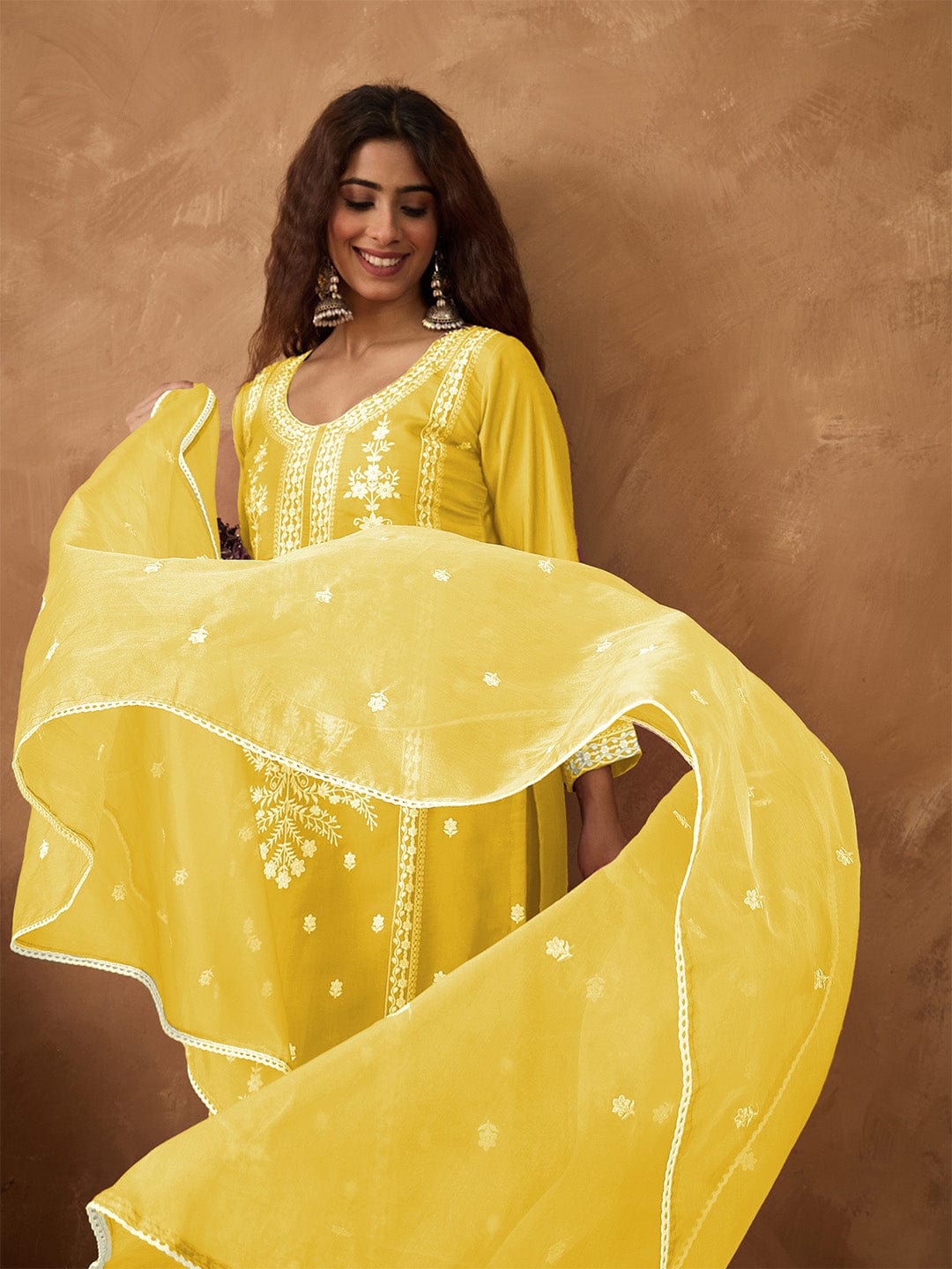 Kurta with thread embroidery paired with trousers with embroidered hem and booti embroidered dupatta