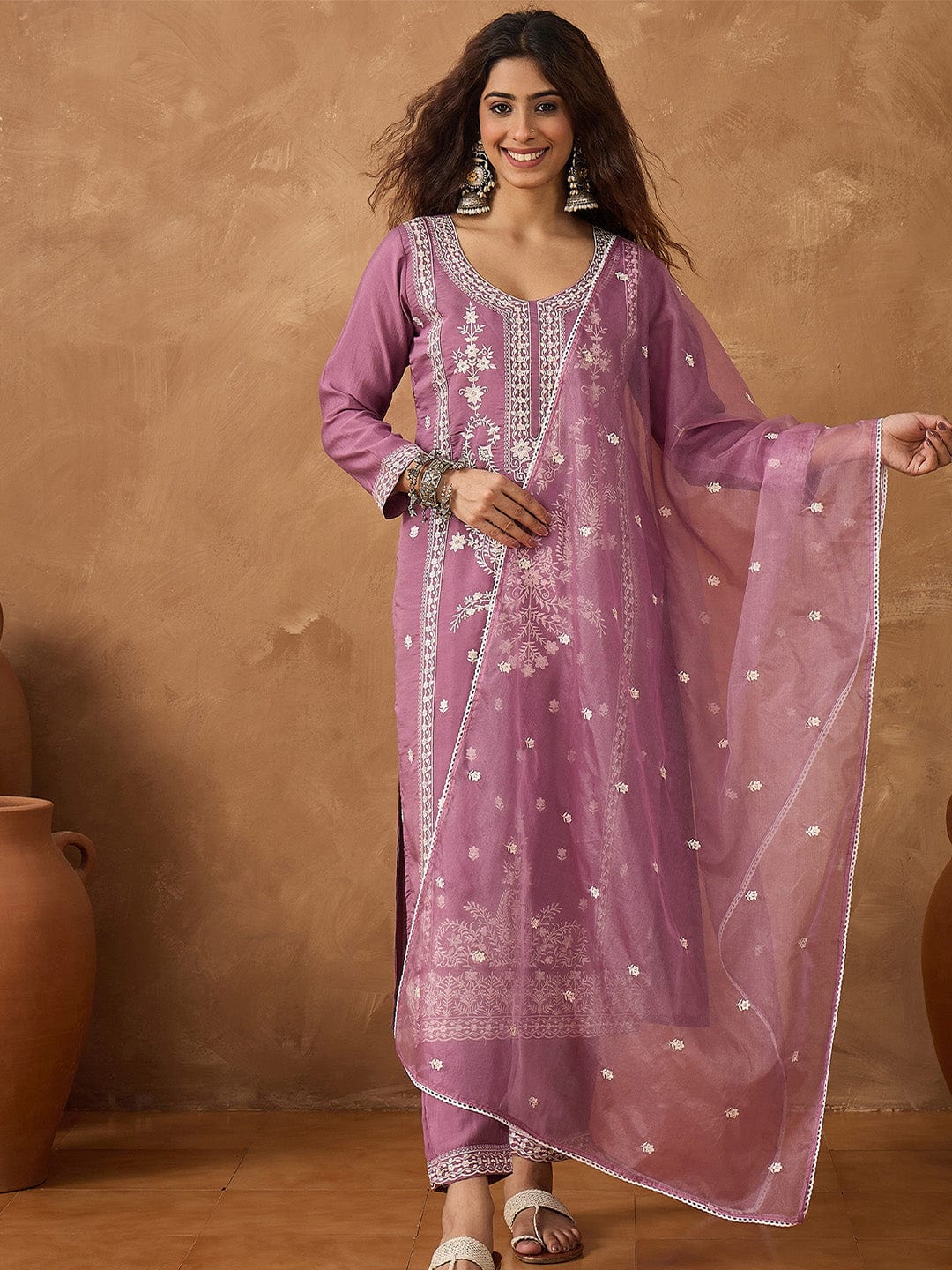 Kurta with thread embroidery paired with trousers with embroidered hem and booti embroidered dupatta