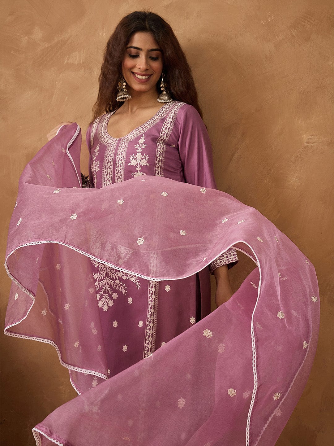 Kurta with thread embroidery paired with trousers with embroidered hem and booti embroidered dupatta