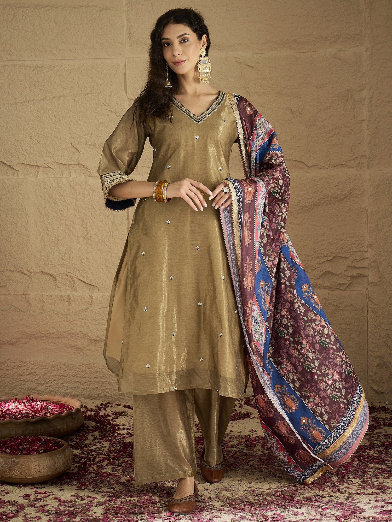 Varanga Women Radiate Festive Charm In This Gold Shimmer Kurta Set With Intricate Lace Detailing, Solid Ankle-Length Trousers, And  Printed Dupatta.