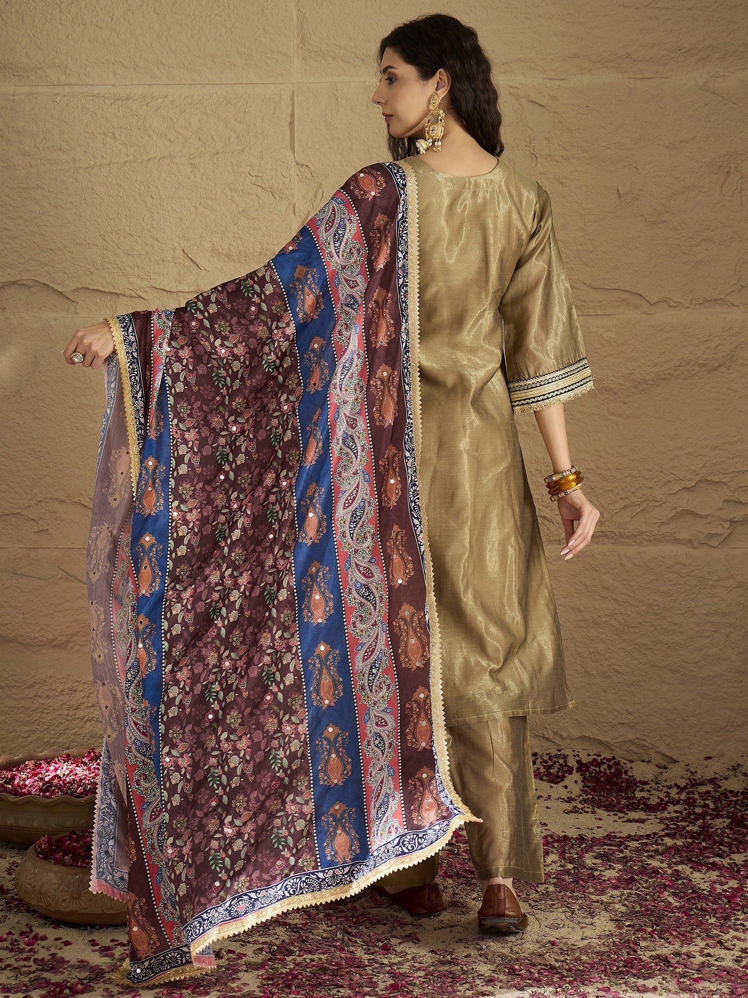 Varanga Women Radiate Festive Charm In This Gold Shimmer Kurta Set With Intricate Lace Detailing, Solid Ankle-Length Trousers, And  Printed Dupatta.