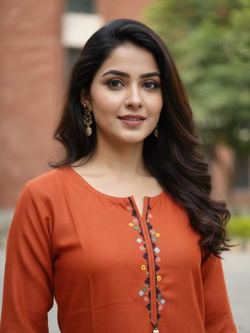 Solid straight-fit kurta with graceful embroidery and a round neckline, paired with full-length elasticated straight trousers.