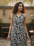 Sleeveless halter-neck floral kurta set in black and white tone, styled with printed full-length trousers.