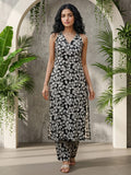 Sleeveless halter-neck floral kurta set in black and white tone, styled with printed full-length trousers.