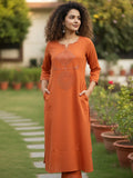 Orange kurta with mirror-detailed round neck paired with a matching trouser for a chic ethnic look.