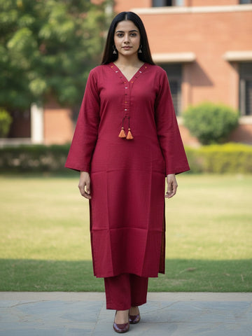 Solid straight-fit kurta with graceful embroidery and a round neckline, paired with full-length elasticated straight trousers.
