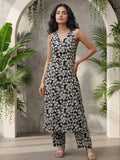Sleeveless halter-neck floral kurta set in black and white tone, styled with printed full-length trousers.