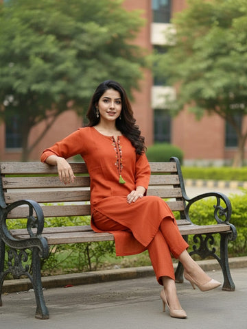 Solid straight-fit kurta with graceful embroidery and a round neckline, paired with full-length elasticated straight trousers.