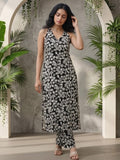 Sleeveless halter-neck floral kurta set in black and white tone, styled with printed full-length trousers.