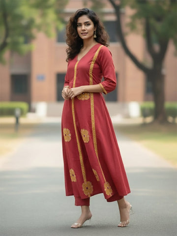 Rust Anarkali kurta set featuring multicolour buta prints, embroidered V-neck and sleeves, paired with solid straight-fit trousers and a tasselled dupatta.