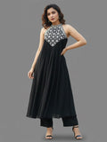 Black halter-neck A-line kurta featuring delicate white floral embroidery with matching solid trousers.