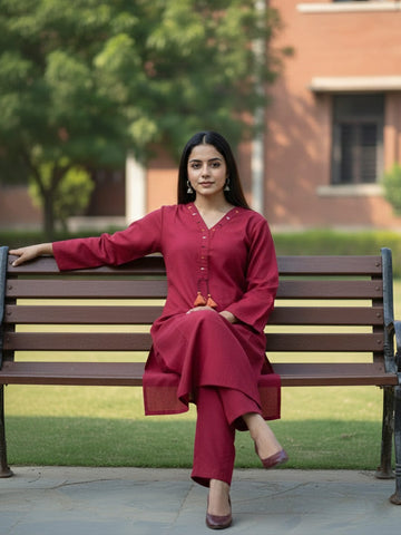 Solid straight-fit kurta with graceful embroidery and a round neckline, paired with full-length elasticated straight trousers.