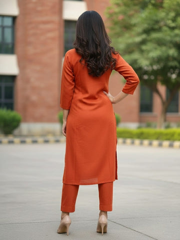 Solid straight-fit kurta with graceful embroidery and a round neckline, paired with full-length elasticated straight trousers.
