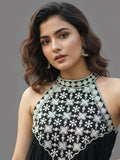 Black halter-neck A-line kurta featuring delicate white floral embroidery with matching solid trousers.