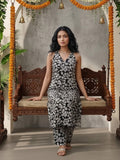 Sleeveless halter-neck floral kurta set in black and white tone, styled with printed full-length trousers.