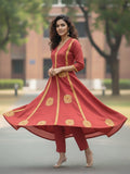 Rust Anarkali kurta set featuring multicolour buta prints, embroidered V-neck and sleeves, paired with solid straight-fit trousers and a tasselled dupatta.
