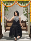 Black halter-neck A-line kurta featuring delicate white floral embroidery with matching solid trousers.
