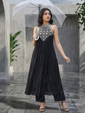 Black halter-neck A-line kurta featuring delicate white floral embroidery with matching solid trousers.