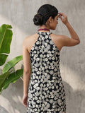 Sleeveless halter-neck floral kurta set in black and white tone, styled with printed full-length trousers.