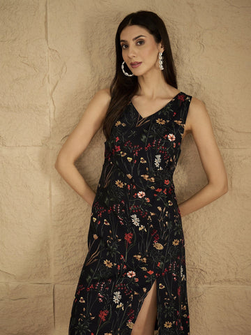 A Sleek Black Floral-Printed Knee-Length Dress With A V-Neckline And Side Slit Sleeveless, Stylish, And Perfect For Effortless Day-To-Evening Charm.