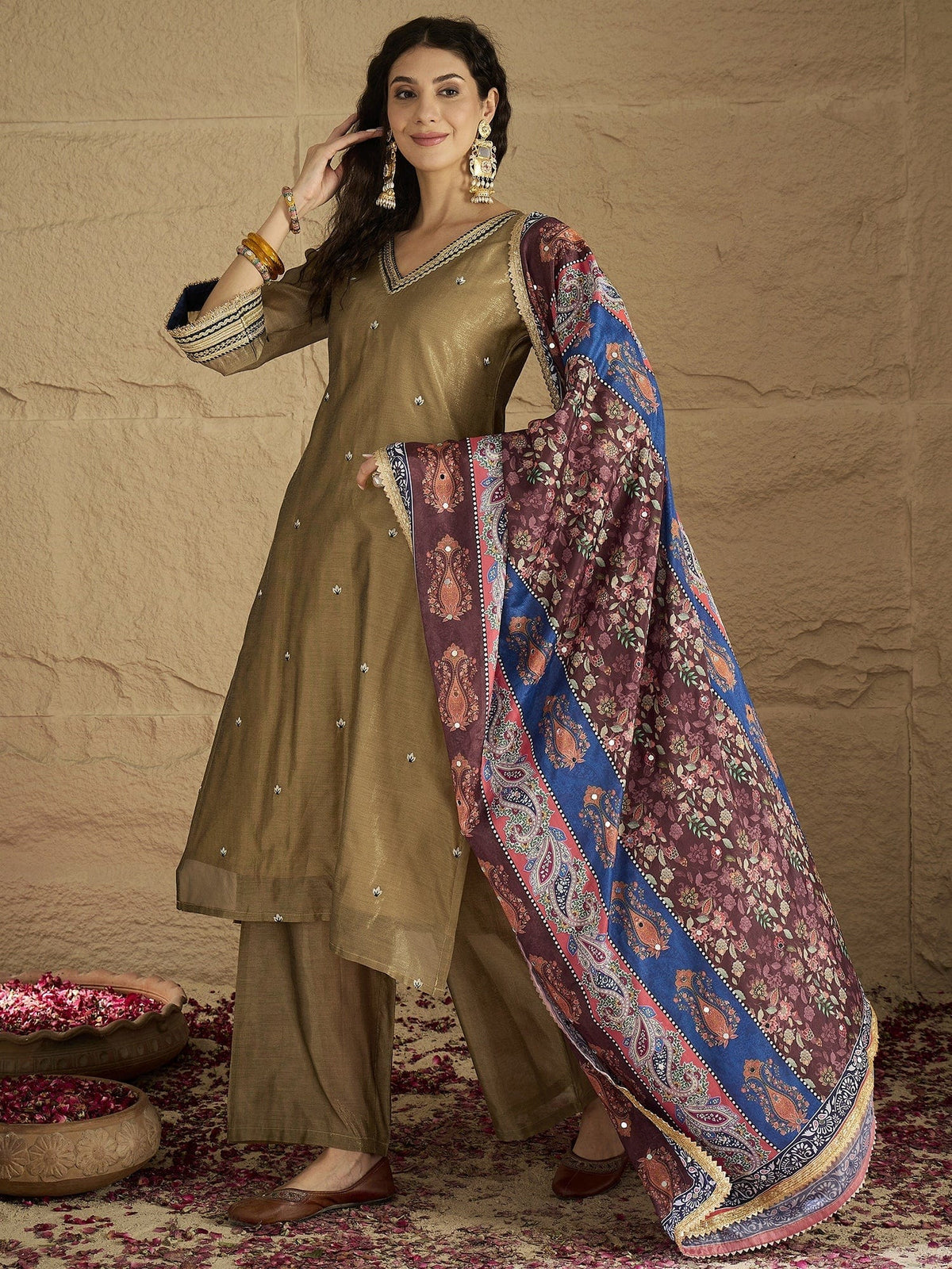 Varanga Women Radiate Festive Charm In This Gold Shimmer Kurta Set With Intricate Lace Detailing, Solid Ankle-Length Trousers, And Printed Dupatta.