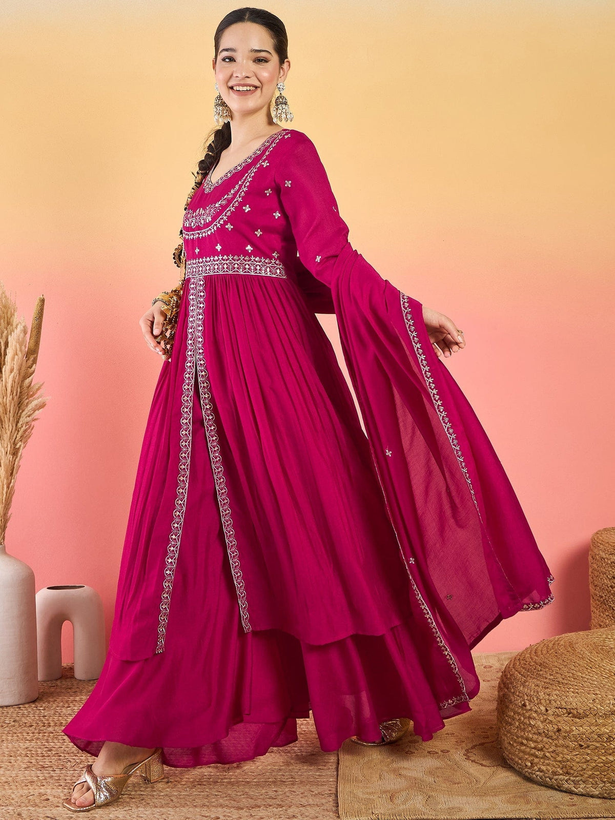 Varanga Fuchsia Anarkali Set Featuring Front-Slit Kurta With Zari-Embroidered Yoke And Border, Paired With A Floor-Length Sharara And A Bordered Dupatta.