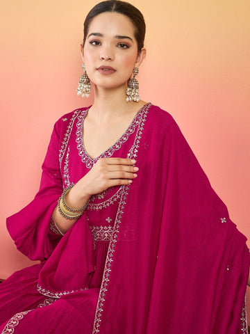 Varanga Fuchsia Anarkali Set Featuring Front-Slit Kurta With Zari-Embroidered Yoke And Border, Paired With A Floor-Length Sharara And A Bordered Dupatta.