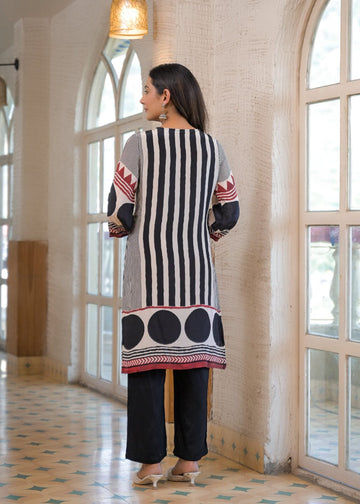 Varanga women's A striking black and white straight kurta set by Varanga, made from smooth Modal silk. It showcases an eye-catching placement print, elevated by delicate thread and mirror embroidery with chic tassel accents.
