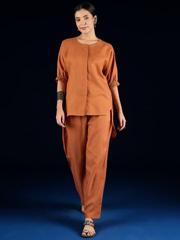 Varanga Rust Straight-Fit Shirt With Puff Sleeves And A Round Neck, Paired With Solid Ankle-Length Straight-Fit Trousers.